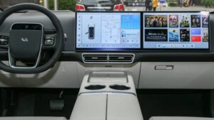 Modern car interior featuring a dual-screen infotainment system, digital dashboard, navigation, and multimedia controls.